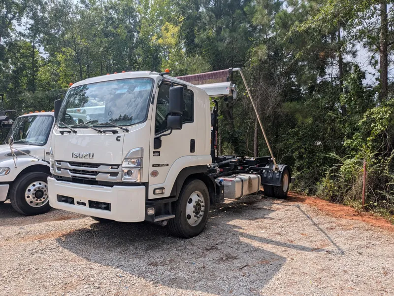 Isuzu FVR hook-lift truck serviced at the customer's yard