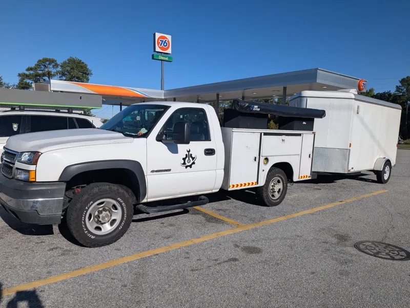 Service truck and parts trailer on the way to a job