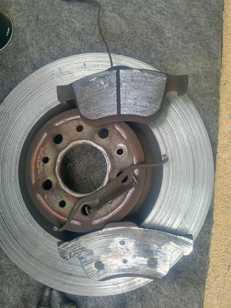 Pads worn down to the backing plate, caught before the rotor was ruined
